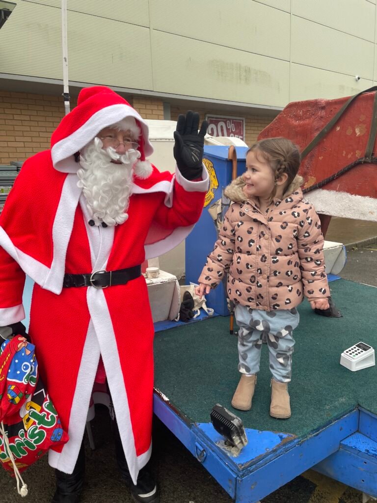 Santa poses with smiling youngster