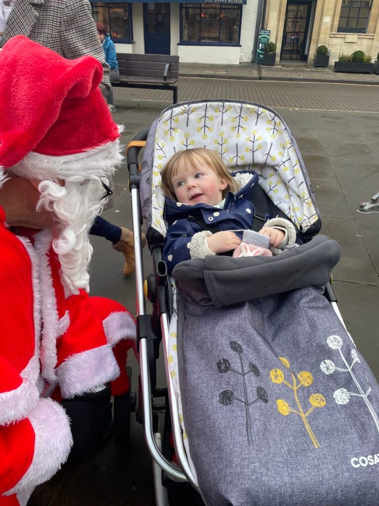 Santa chatting to youngster in pram