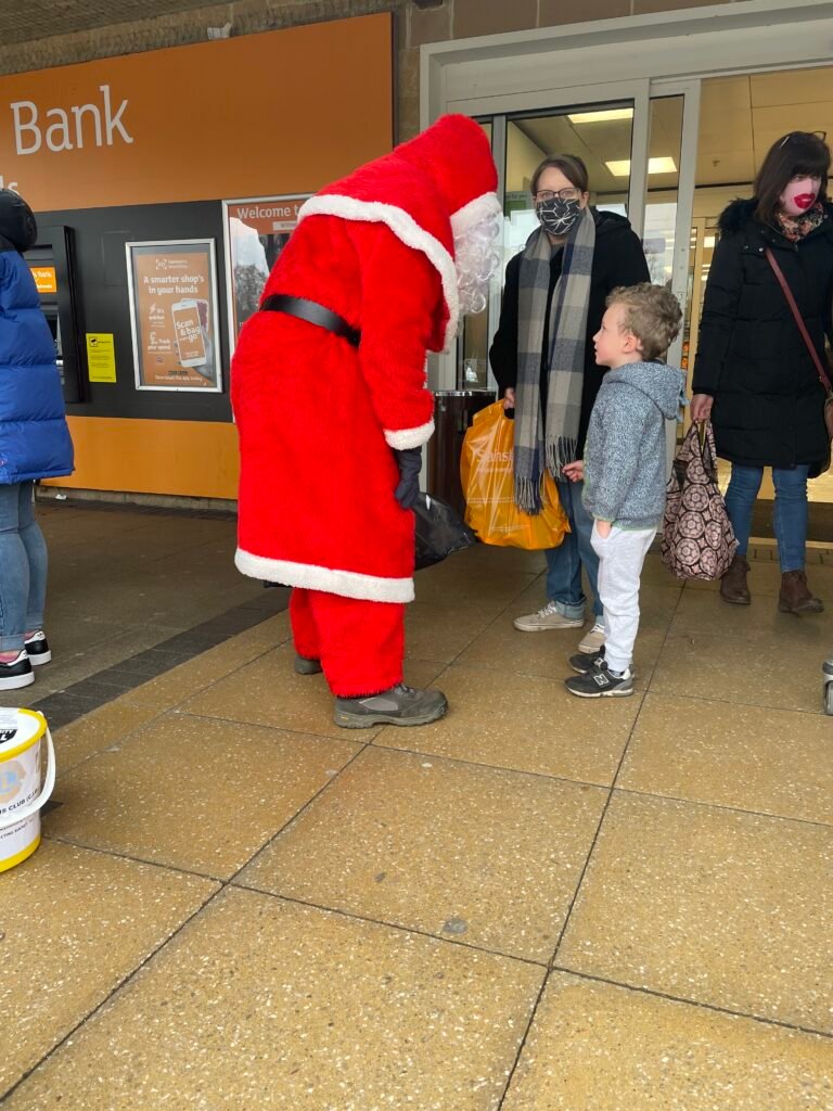Santa chats to young boy overseen by mum