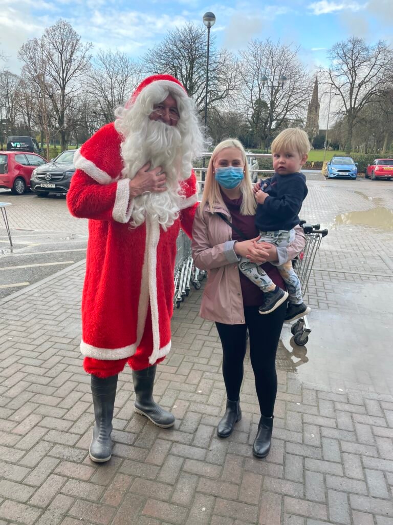 Santa, mum and youngster pose for picture